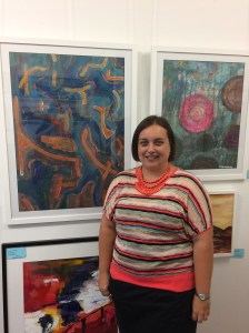 Pictured: Margo Humphries with two of her paintings for sale at Ocean Blue Gallery's current exhibition: On the left: “Embarrassed Watermelon” $500 framed 72 cm w x 96 cm h. Acrylic on paper. On the right: “Happy Trails” $400 framed 63 cm w x 77 cm h. Acrylic & ink on board.
